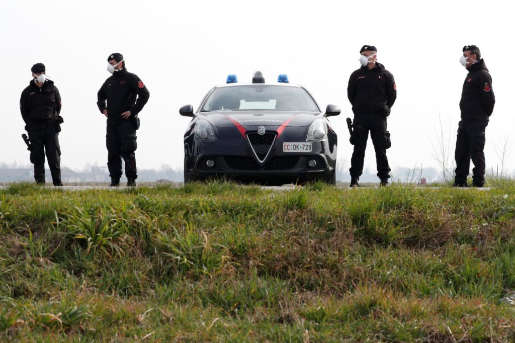 Carabinieri officers wearing face masks on patrol.