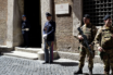 Soldiers and police officers stand guard outside the Italian national anti-mafia services HQ in Rome.