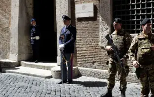 Soldiers and police officers stand guard outside the Italian national anti-mafia services HQ in Rome.